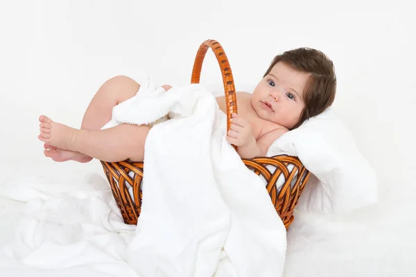 Baby in basket on white towel, healthcare concept — Stock Photo, Image