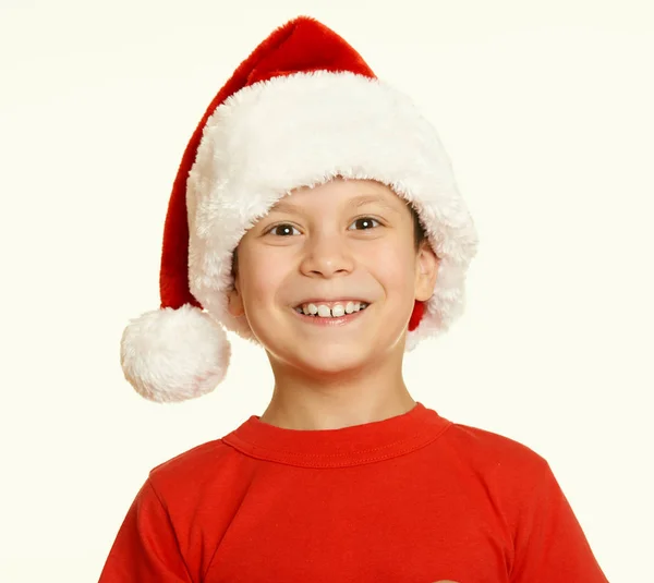 Boy child portrait in santa hat, having fun and emotions, winter holiday concept, yellow toned Stock Image