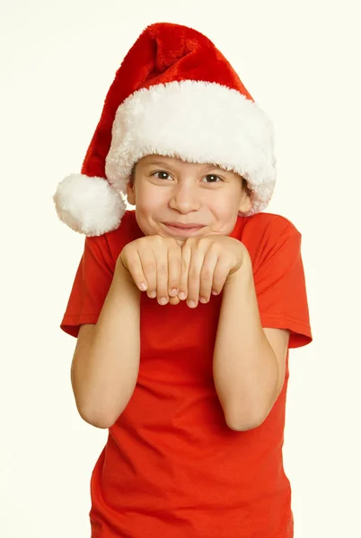 Портрет хлопчика в капелюсі Санта, розваги та емоції, концепція зимових канікул, жовтий тонований — стокове фото