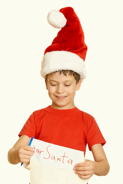 Αγόρι με κόκκινο καπέλο με μακρά κύλισης επιθυμεί να Σάντα - χειμερινών διακοπών Χριστουγέννων έννοια, κίτρινο, ήπια — Φωτογραφία Αρχείου