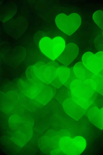 Green color heart bokeh background photo. Abstract holiday, celebration backdrop. — Stock Photo, Image
