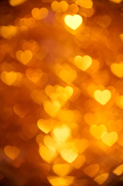 Golden color heart bokeh background photo. Abstract holiday, celebration backdrop. — Stock Photo, Image