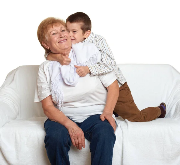 Family portrait on white background, happy people sit on sofa. Grandmother with grandchild. — Stock Photo, Image