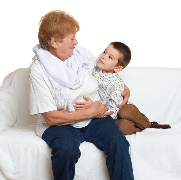 Family portrait on white background, happy people sit on sofa. Grandmother with grandchild. — Stock Photo, Image