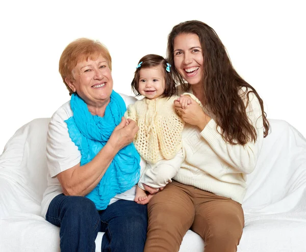 Children with mother and grandmother. Family portrait on white background, happy people sit on sofa. — Stock Photo, Image