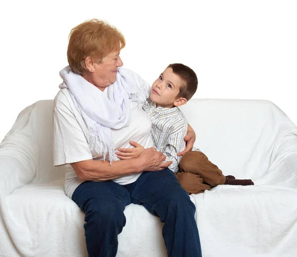 Family portrait on white background, happy people sit on sofa. Grandmother with grandchild. — Stock Photo, Image