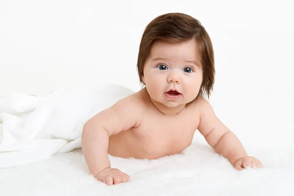 Baby lie on white towel. Child in bed. — Stock Photo, Image