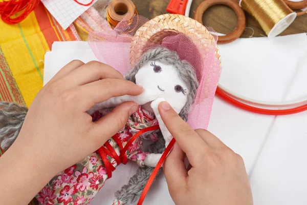 Child hand making dress for handmade doll, learn to sewing — Stock Photo, Image