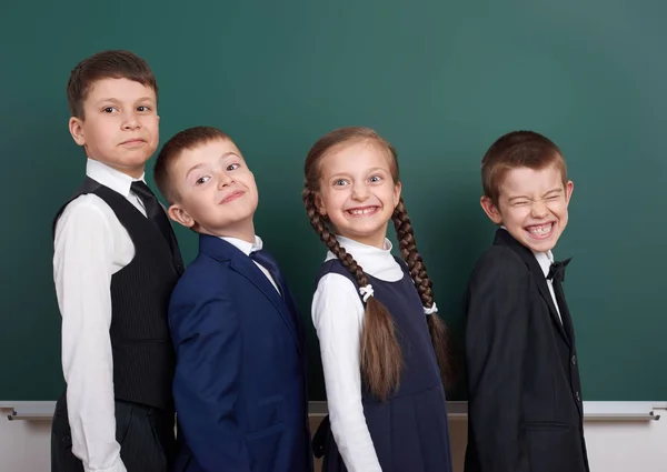 Écolier près du tableau blanc, habillé en costume noir classique, élève de groupe, concept éducatif — Photo