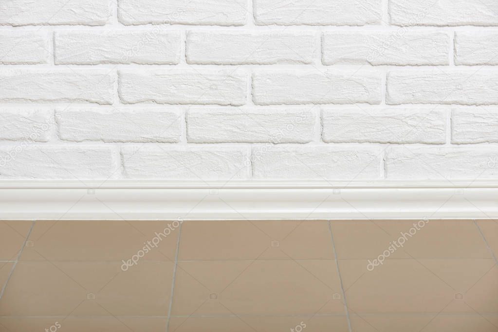white brick wall with tiled floor closeup photo, abstract background photo