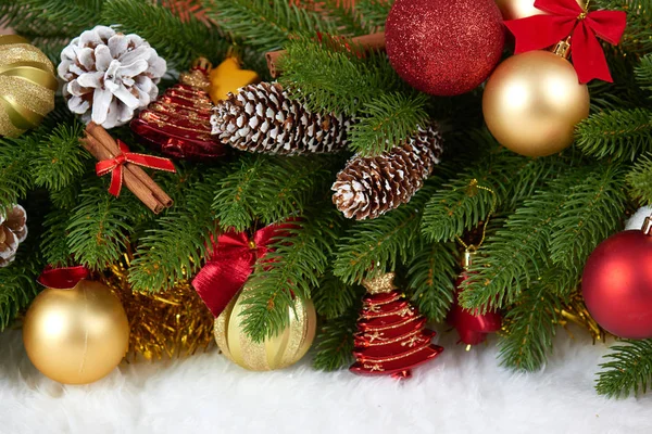 Kerstdecoratie op fir tree branch close-up, geschenken, xmas bal, kegel en andere objecten op witte lege ruimte bont, concept van de vakantie, plaats voor tekst — Stockfoto