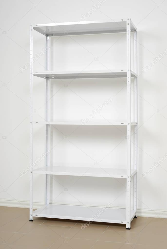 white metal rack near the wall, empty shelves