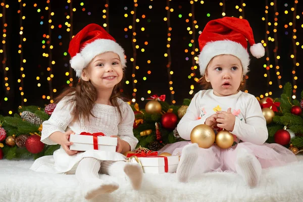 Child girl portrait in christmas decoration, happy emotions, winter holiday concept, dark background with illumination and boke lights Royalty Free Stock Photos