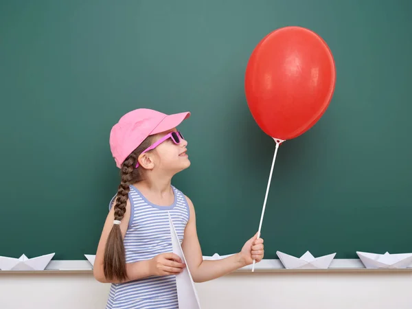 Uczennica z papieru samolot i balon grać w pobliżu tablica, pustej przestrzeni, koncepcja edukacji — Zdjęcie stockowe