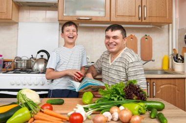 Baba ve çocuk yemek kitabı ve seçim yemekleri okuma. Mutlu f