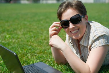 Kadın defter ile yeşil çim üzerinde yalan