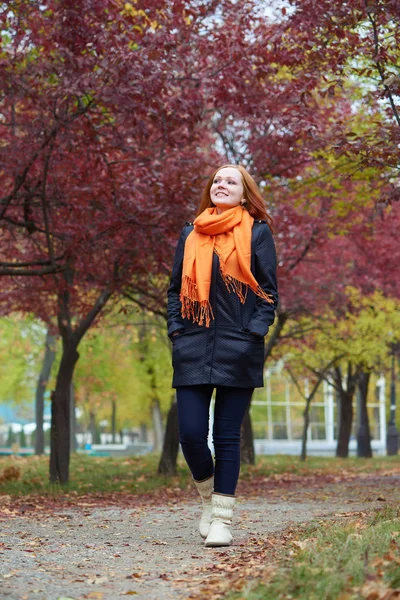 genç kadın yürüyüşüne patika sonbahar park, Sarı yapraklar ve ağaçlar
