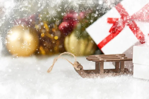 Toy sleigh and Christmas decorations as background — Stock Photo, Image