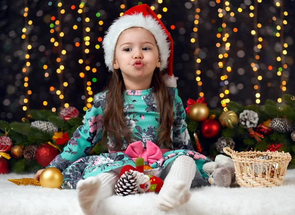 Девушка с эмоциями в рождественское украшение с подарком, темный фон с освещением и бокс-огни, зимний праздник концепции — стоковое фото