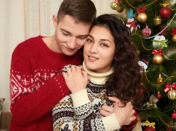 Happy couple near christmas tree in home. Winter holiday and love concept. Royalty Free Stock Photos