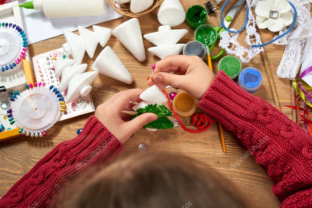 Children make crafts and toys, christmas tree and other. Painting watercolors. Top view. Artwork workplace with creative accessories. Flat lay art tools.