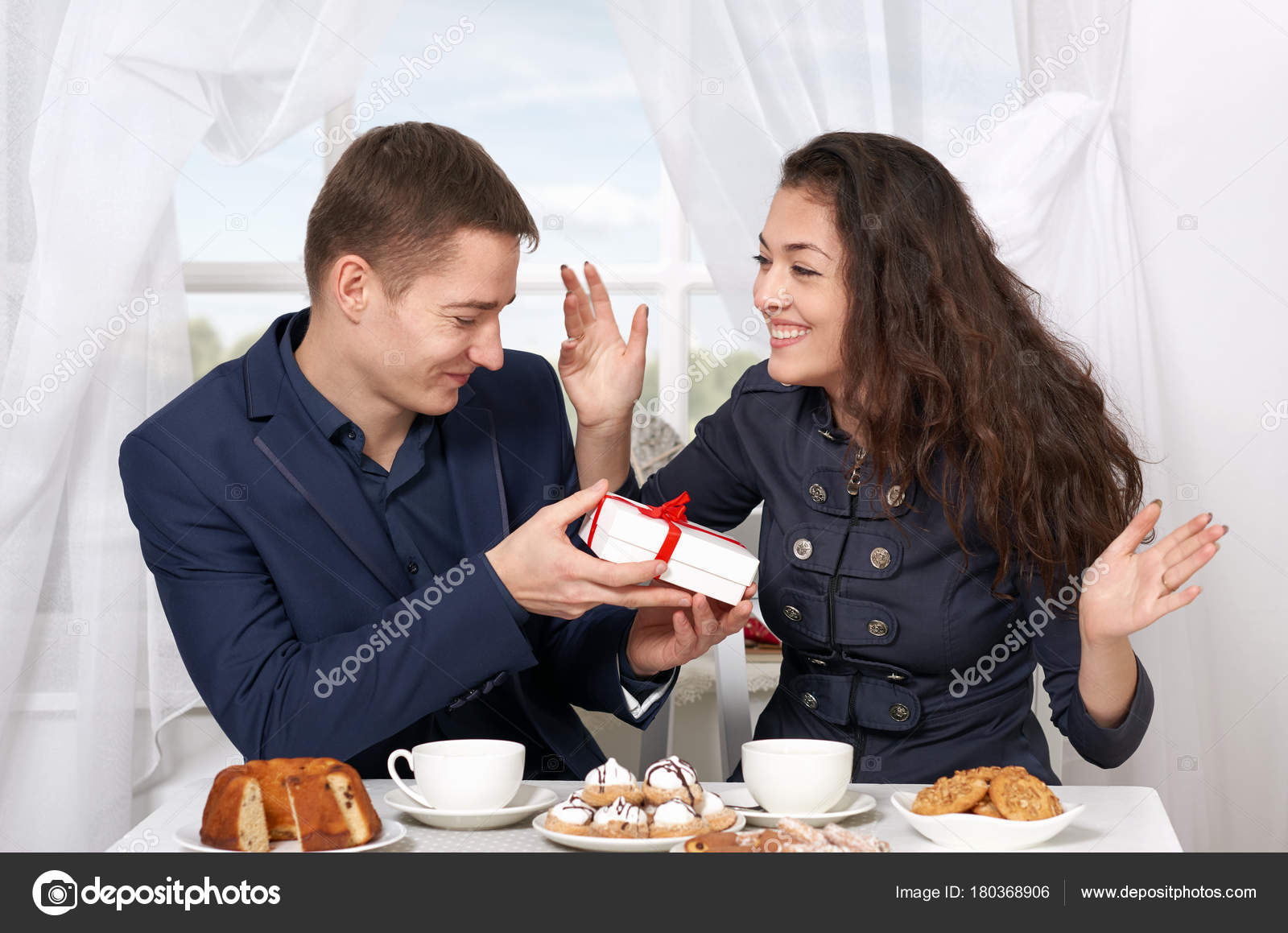 Happy couple drinking coffee and having fun, man give very funny gifts - love and holiday concept Stock Photo by ©soleg 180368906 Happy couple drinking coffee and having fun, man give very funny gifts - love and holiday concept Stock Photo by ©soleg 180368906
