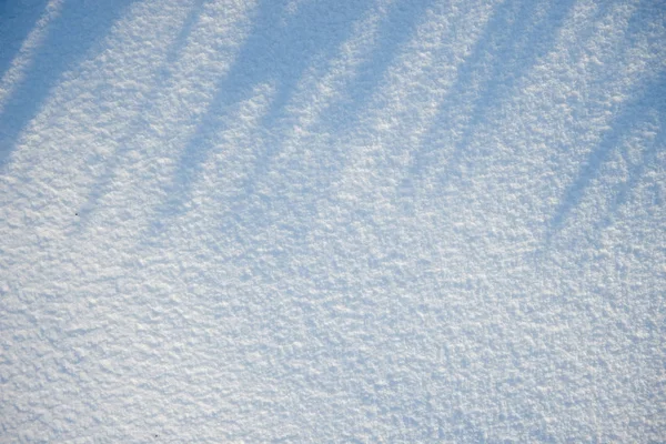 雪のテクスチャや背景フラット横たわっていた、トップ ビュー、きれいな、明るい晴れた日に誰も影で — ストック写真