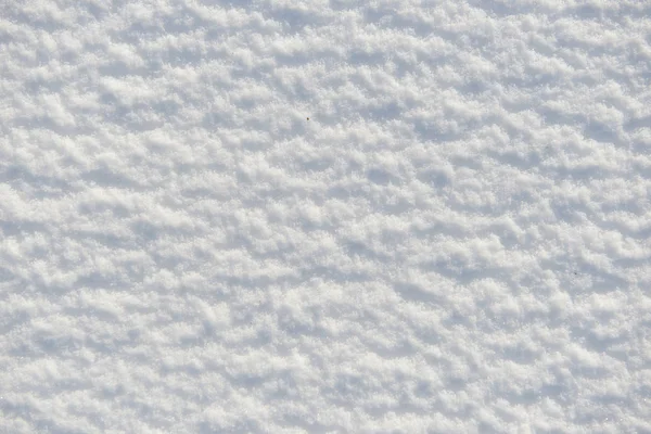 Neve per texture o sfondo nella giornata di sole, luce intensa con ombre, posa piatta, vista dall'alto, pulito e nessuno — Foto Stock