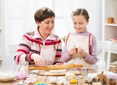 Anne ve kızı evde yemek, çörekler için hamur yapma