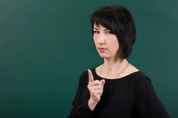 Girl teacher posing by chalk Board, learning concept, green background, Studio shot — Stock Photo, Image