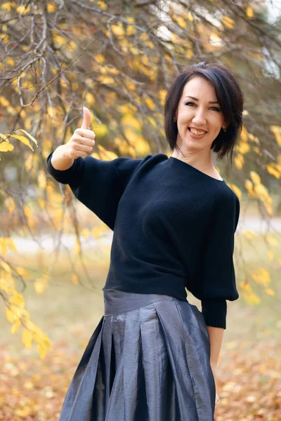 Mulher bonita e elegante de pé e posando em um parque da cidade no outono — Fotografia de Stock