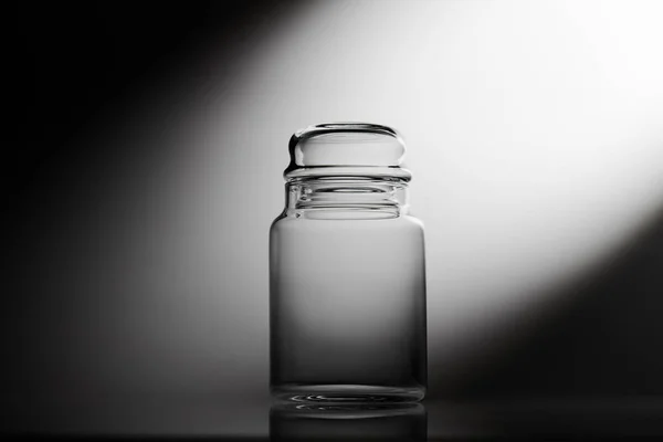 Empty glass jar on a black and white background — Stock Photo, Image