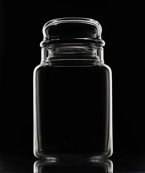 White silhouette of empty glass jar on a black background — Stock Photo, Image