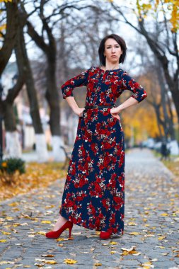 Angry woman posing in a city street, autumn season