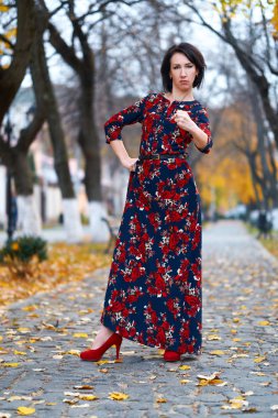 Angry woman posing in a city street, autumn season
