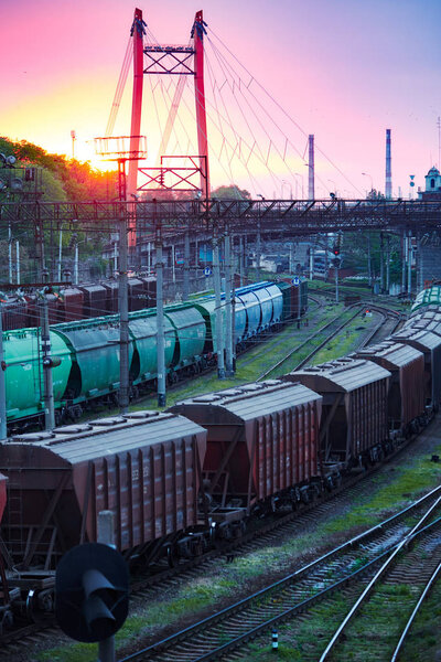 railroad transportation, freight cars in industrial seaport at sunset