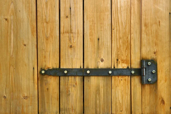 Iron latch and yellow wooden gate closeup on the ranch house for background or texture — Stock Photo, Image
