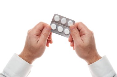Man hand with pills blister isolated on white background. White shirt, business style. Medicament and food supplement for health care. Pharmaceutical industry. Pharmacy.