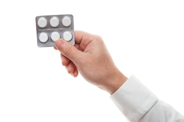 Man hand with pills blister isolated on white background. White shirt, business style. Medicament and food supplement for health care. Pharmaceutical industry. Pharmacy. — Stok fotoğraf