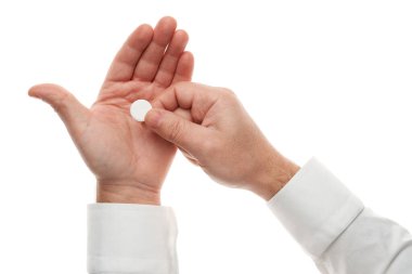Man hand with one big white pill isolated on white background. White shirt, business style. Medicament and food supplement for health care. Pharmaceutical industry. Pharmacy.