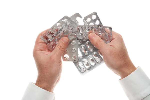 Man hand with used pills blister isolated on white background. White shirt, business style. Medicament and food supplement for health care. Pharmaceutical industry. Pharmacy. — Stockfoto