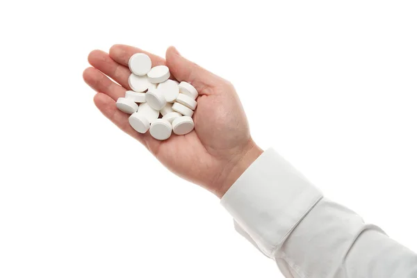 Man hand with handful of big white pills isolated on white background. White shirt, business style. Medicament and food supplement for health care. Pharmaceutical industry. Pharmacy. — Stok fotoğraf