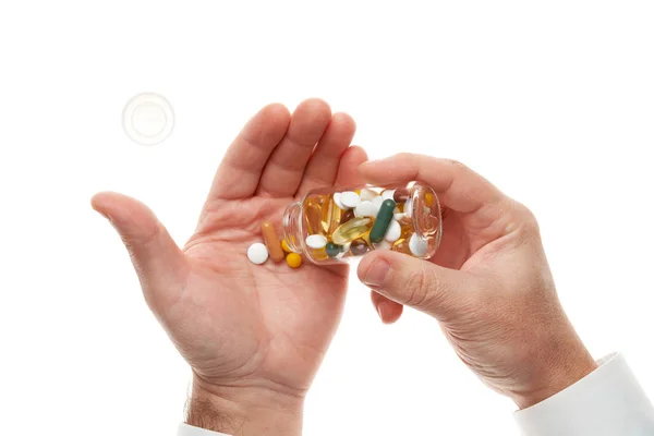 Man hand opening glass bottle full of pills, tablets, vitamins, drugs, capsules isolated on white background. White shirt, business style. Health care concept. Pharmaceutical industry. Pharmacy. — Stok fotoğraf