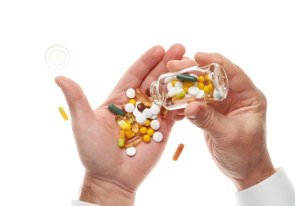 Man hand opening glass bottle full of pills, tablets, vitamins, drugs, capsules isolated on white background. White shirt, business style. Health care concept. Pharmaceutical industry. Pharmacy. — Stockfoto