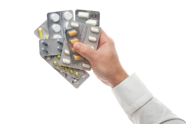 Man hand with pills blister isolated on white background. White shirt, business style. Medicament and food supplement for health care. Pharmaceutical industry. Pharmacy. — Stok fotoğraf