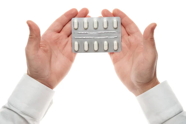 Άνδρας χέρι με χάπια κυψέλη απομονώνονται σε λευκό φόντο. Λευκό πουκάμισο, επιχειρηματικό στυλ. Φάρμακα και συμπληρώματα διατροφής για την υγειονομική περίθαλψη. Φαρμακευτική βιομηχανία. Φαρμακείο. — Φωτογραφία Αρχείου