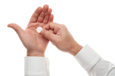 Man hand with one big white pill isolated on white background. White shirt, business style. Medicament and food supplement for health care. Pharmaceutical industry. Pharmacy.