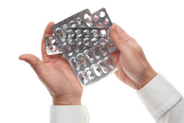 Mano de hombre con ampolla de píldoras usadas aislada sobre fondo blanco. Camisa blanca, estilo de negocios. Medicamento y complemento alimenticio para la atención médica. Industria farmacéutica. Farmacia . — Foto de Stock