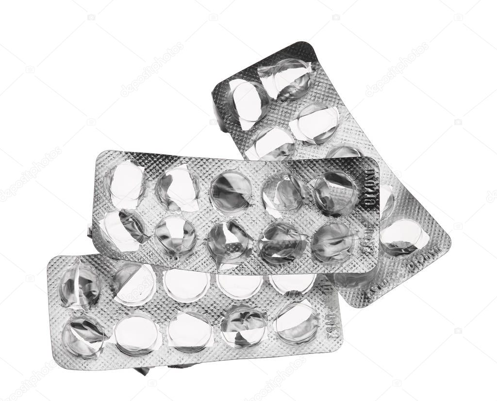Old and used pills blisters packaging, empty, opened with no pills on white background - health care and medicines concept. Pharmaceutical industry. Pharmacy.