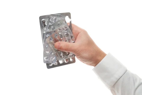 Uomo mano con pillole usate blister isolato su sfondo bianco. Camicia bianca, stile business. Medicamenti e integratori alimentari per l'assistenza sanitaria. Industria farmaceutica. Farmacia . — Foto Stock